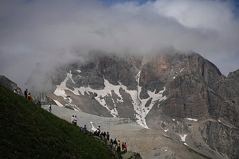 Spectators wait the riders to pass in the Col du Galibier